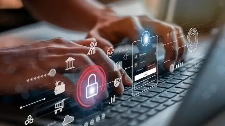 Hands typing on a laptop with digital security icons overlayed, symbolizing data protection, privacy safeguards, and secure digital transactions—contextual to India's Digital Personal Data Protection Bill.