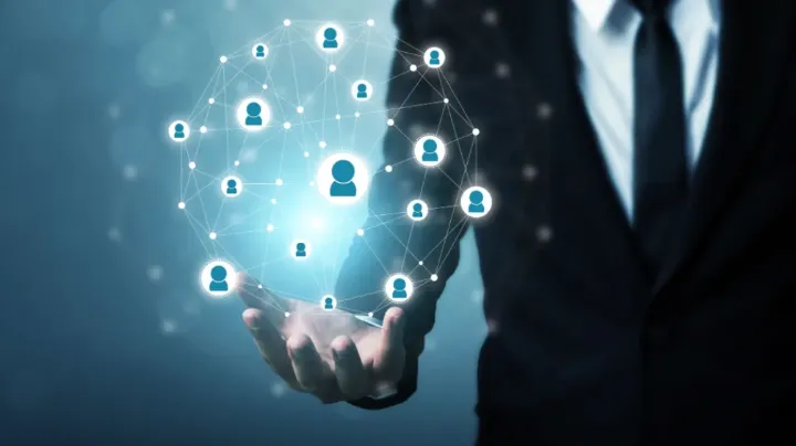A recruiter in a suit holding a glowing digital network of connected candidate icons, symbolizing the role of technical knowledge in modern hiring processes.