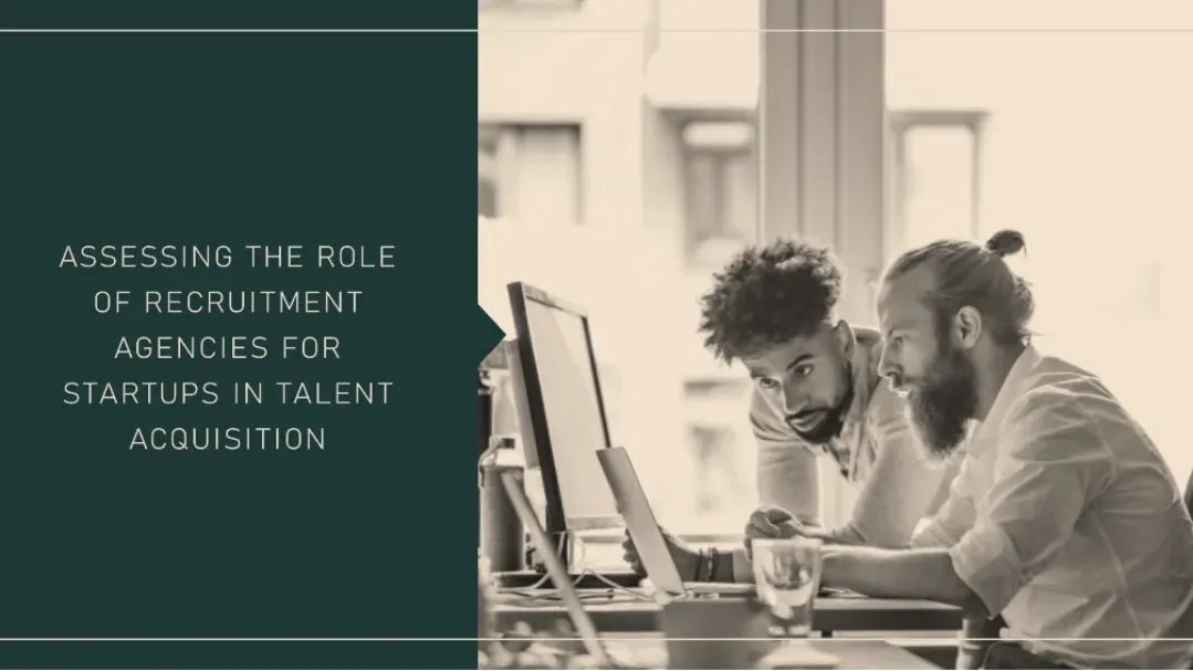 Two startup founders collaborating at a desk, assessing the role of a recruitment agency in building their talent acquisition strategy.